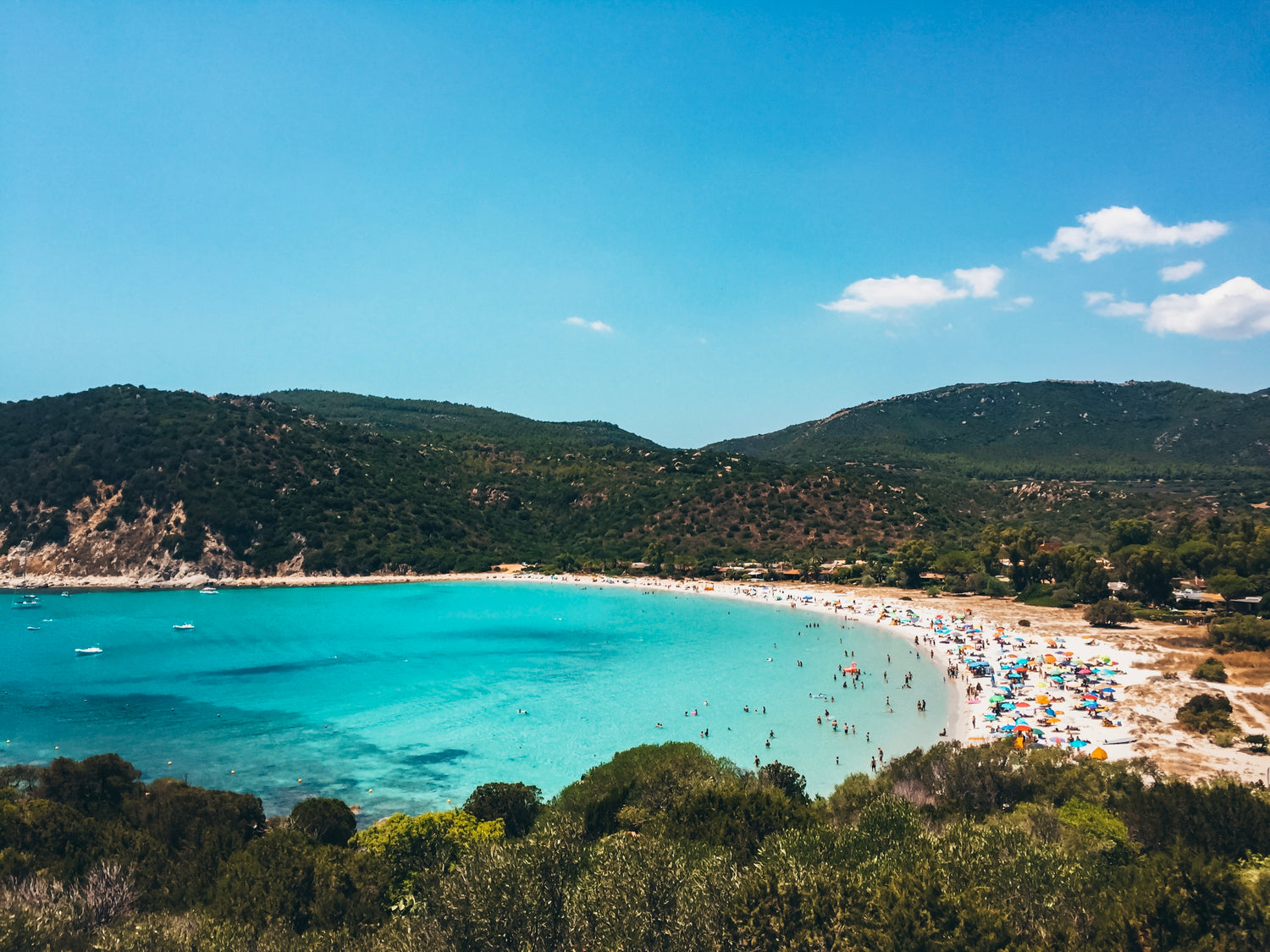 blue-water-bay-with-busy-beach