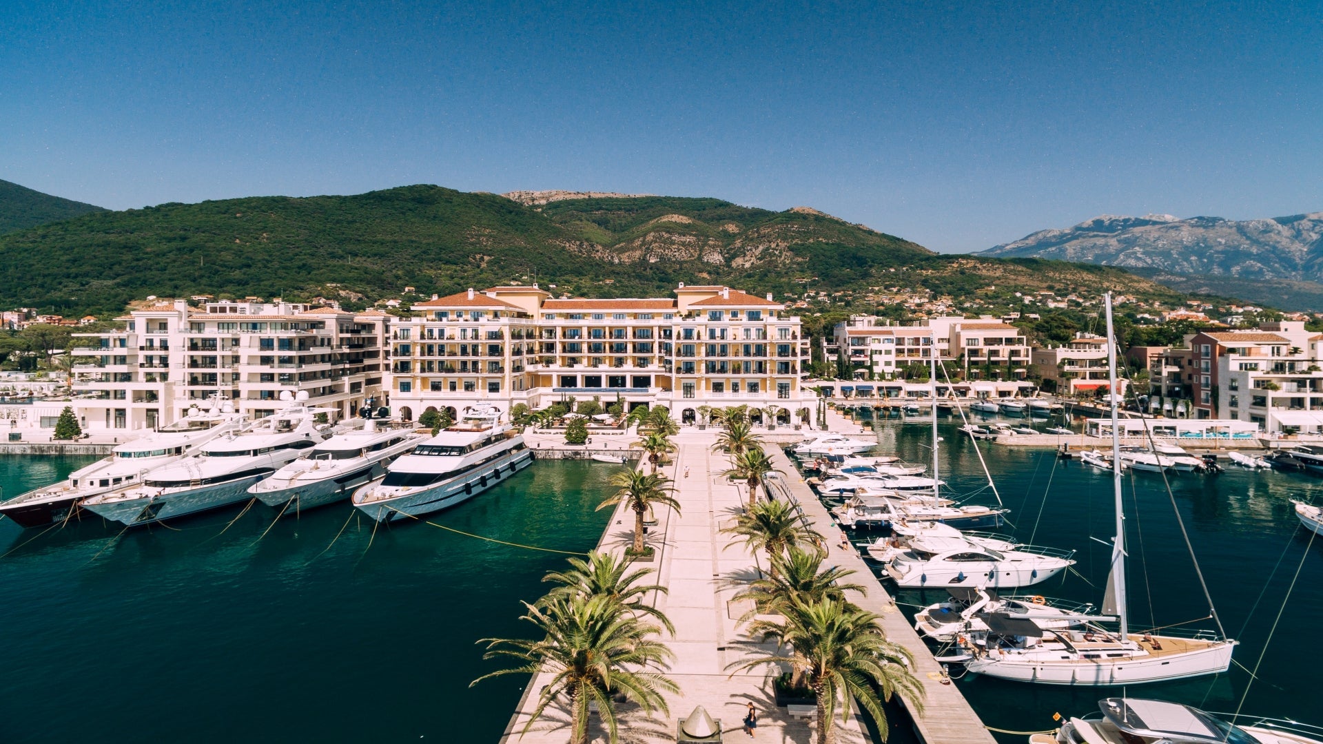 pier-leads-to-a-luxurious-expensive-hotel-in-the-water-tivat-porto-montenegro-travel-trip-tour-excursion