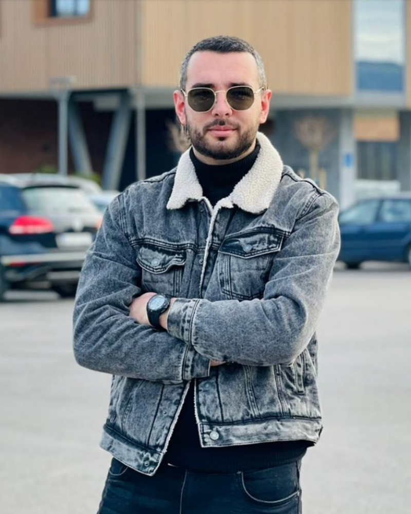 A person from Montenegro in a denim shirt and black sunglasses