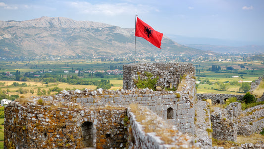 red albanian flag with black eagle waving over wall-rozafa-castle